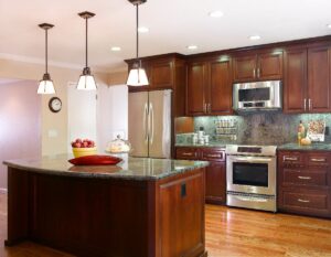 cherry cabintes, silver hardware, granite counter, island, recessed lighting, stainless steel applicances